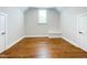 Bedroom features hardwood flooring, neutral walls, trim, and bright window at 108 Clements Dr, Morrisville, NC 27560