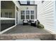 Cozy covered patio featuring comfortable seating, plants, and seamless transition to the outdoors at 108 Clements Dr, Morrisville, NC 27560