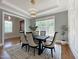 Dining room with a table, six chairs, a modern light fixture, and large windows at 108 Clements Dr, Morrisville, NC 27560
