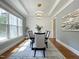 Dining room featuring wainscoting, ample sunlight, and a modern, decorative chandelier at 108 Clements Dr, Morrisville, NC 27560