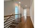 Upstairs hallway with hardwood floors and a view of an open door at 108 Clements Dr, Morrisville, NC 27560
