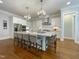 Spacious white kitchen with a large island, stainless steel appliances, and hardwood floors at 108 Clements Dr, Morrisville, NC 27560