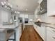 Beautiful kitchen with a stainless range hood, gas cooktop, and white cabinets at 108 Clements Dr, Morrisville, NC 27560