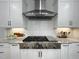Close up view of a modern gas cooktop and range hood in a well-lit kitchen at 108 Clements Dr, Morrisville, NC 27560