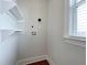 A bright laundry area with shelving and connections for a washer and dryer at 108 Clements Dr, Morrisville, NC 27560
