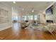 Open-concept living room with hardwood floors, modern furniture, and a fireplace with built-ins at 108 Clements Dr, Morrisville, NC 27560