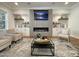 Cozy living room featuring a fireplace, built-in cabinets, and comfortable seating arrangements at 108 Clements Dr, Morrisville, NC 27560