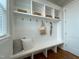 Mudroom area with built-in bench, storage cubbies, hooks and wood flooring at 108 Clements Dr, Morrisville, NC 27560