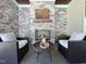 Charming outdoor fireplace with stone surround, complemented by comfortable seating and a decorative wood beam at 108 Clements Dr, Morrisville, NC 27560