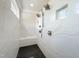 Contemporary tiled shower featuring dual shower heads, bench, and a black tiled floor at 108 Clements Dr, Morrisville, NC 27560