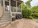 A brick patio area with a grill and stairs to a screened in porch are visible at 111 Gathering Place Pl, Durham, NC 27713