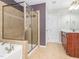 Bathroom featuring tiled walk-in shower, soaking tub, and neutral color scheme for a spa-like retreat at 111 Gathering Place Pl, Durham, NC 27713