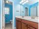 Vibrant blue bathroom featuring double sink vanity and a private toilet room for added convenience at 111 Gathering Place Pl, Durham, NC 27713