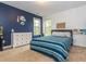 Bedroom with pops of blue and ample natural light offers a bright and inviting living space at 111 Gathering Place Pl, Durham, NC 27713
