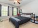 Bedroom with a dark gray bed and lots of natural light creates a cozy and inviting space at 111 Gathering Place Pl, Durham, NC 27713