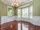 A dining room showcasing a bay window, wainscoting, and a chandelier at 111 Gathering Place Pl, Durham, NC 27713