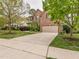 Traditional brick home with a spacious driveway and well-maintained lawn, showing suburban charm at 111 Gathering Place Pl, Durham, NC 27713