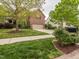Beautiful home with a well-manicured lawn, complemented by colorful landscaping and a brick driveway at 111 Gathering Place Pl, Durham, NC 27713