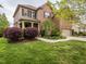 Charming brick home featuring mature landscaping, a welcoming front porch, and an attached two-car garage at 111 Gathering Place Pl, Durham, NC 27713