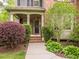 Charming home exterior with a covered front porch and beautiful landscaping, creating curb appeal at 111 Gathering Place Pl, Durham, NC 27713