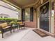 Inviting front porch with wicker furniture, a wreath, and a welcome mat, perfect for relaxing outdoors at 111 Gathering Place Pl, Durham, NC 27713