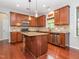 Spacious kitchen features granite countertops, wood cabinets, and an island at 111 Gathering Place Pl, Durham, NC 27713