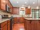 A kitchen showcasing stainless steel appliances, wooden cabinets, and tile backsplash at 111 Gathering Place Pl, Durham, NC 27713