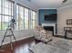 Bright living room with large windows, fireplace, hardwood floors, and comfortable seating arrangements at 111 Gathering Place Pl, Durham, NC 27713
