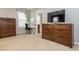 Bedroom with a desk beside the bathroom is furnished with a wooden dresser for ample storage at 111 Gathering Place Pl, Durham, NC 27713