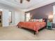 A large bed sits as the focal point in the main bedroom that features neutral walls and recessed lighting at 111 Gathering Place Pl, Durham, NC 27713
