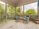 Cozy screened-in porch with comfortable seating, perfect for enjoying the outdoors at 111 Gathering Place Pl, Durham, NC 27713