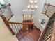 Elegant staircase showcasing wood steps, dark iron railings, and a clear view of the front entrance at 111 Gathering Place Pl, Durham, NC 27713