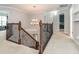 Carpeted staircase leading down, featuring dark wood railings and a stylish chandelier above at 111 Gathering Place Pl, Durham, NC 27713