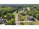 Neighborhood aerial view of a landscaped community featuring many homes with manicured lawns at 121 Westchase Run, Sanford, NC 27330