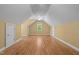 Spacious attic with hardwood floors, sloped ceilings, and natural light from window at 121 Westchase Run, Sanford, NC 27330