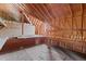 View of the unfinished attic, featuring plywood walls, exposed rafters, and natural lighting at 121 Westchase Run, Sanford, NC 27330