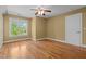 Spacious bedroom with hardwood floors, natural light, and a ceiling fan at 121 Westchase Run, Sanford, NC 27330