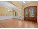 The dining room is illuminated by a chandelier, featuring hardwood floors and bright natural light at 121 Westchase Run, Sanford, NC 27330