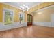Bright dining room featuring hardwood floors, large windows, and a classic chandelier for elegant dining at 121 Westchase Run, Sanford, NC 27330