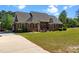 Charming brick home featuring a lush green lawn, an expansive backyard, and beautiful curb appeal at 121 Westchase Run, Sanford, NC 27330