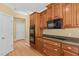 Kitchen with granite counters, wood cabinets, double ovens, and stovetop at 121 Westchase Run, Sanford, NC 27330