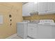 Laundry room featuring washer, dryer, sink and white cabinets at 121 Westchase Run, Sanford, NC 27330