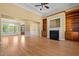 Open-concept living room featuring hardwood floors, a fireplace, built-in bookshelves, and natural light at 121 Westchase Run, Sanford, NC 27330