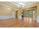 Spacious living room featuring beautiful hardwood floors and access to multiple rooms in the home at 121 Westchase Run, Sanford, NC 27330