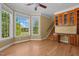 Well-lit living room with hardwood floors, bay windows, and built-in bookshelves and cabinets at 121 Westchase Run, Sanford, NC 27330