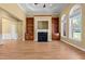 Well-lit living room with hardwood floors, built-in bookshelves, fireplace and a ceiling fan at 121 Westchase Run, Sanford, NC 27330