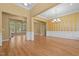 Spacious living area with hardwood floors, elegant columns, and access to the dining room and fireplace at 121 Westchase Run, Sanford, NC 27330