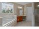 Bathroom with a corner tub, vanity, and a window with stained glass at 121 Westchase Run, Sanford, NC 27330