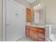 Bathroom with a vanity, cabinets and a white door with satin nickel hardware at 121 Westchase Run, Sanford, NC 27330