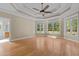 Spacious main bedroom features tray ceilings, large windows and beautiful hardwood flooring at 121 Westchase Run, Sanford, NC 27330